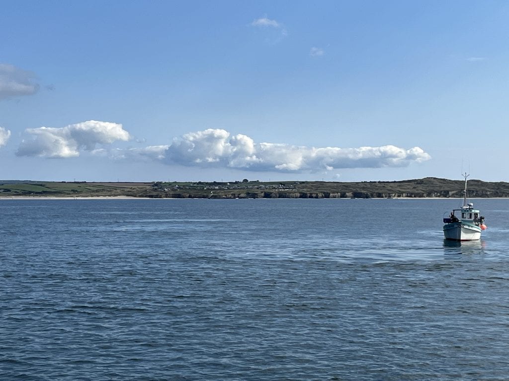 A group of scientists sailing off St Ives Bay to measure the effect of Planetary’s OAE intervention. The 5-day trial took place in September 2022. The smooth areas of water, where the wastewater enters the ocean through openings in the pipeline below, indicates to the scientists where best to take their samples.